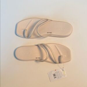 CROCS Miami Toe Loop Sandals in Cream.